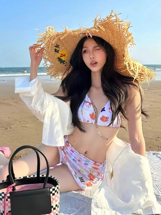 Woman in a Hello Kitty bikini set with sarong and straw hat on a beach